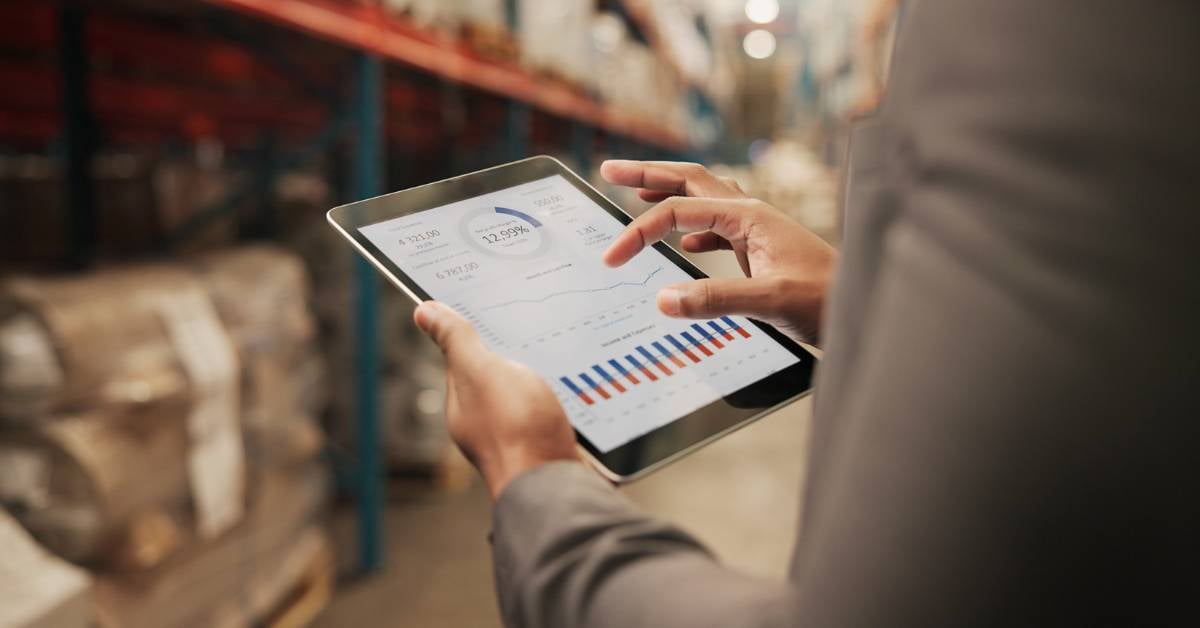A worker holds a tablet and uses a user-friendly tool to get insight into their environment