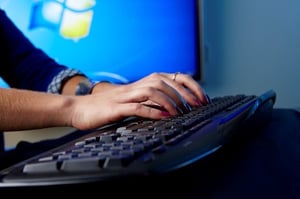 image of an employee typing on a keyboard