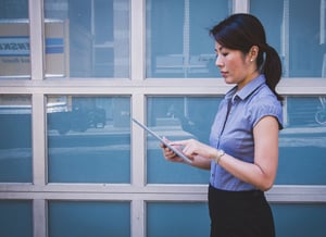 This is a picture of a woman using a tablet device.