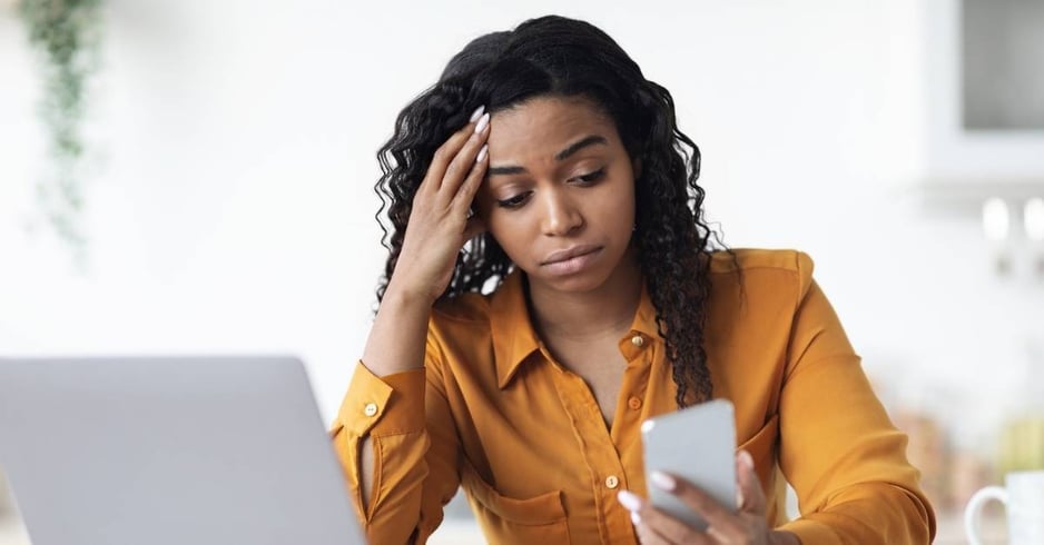 Woman looking frustrated at her cell phone
