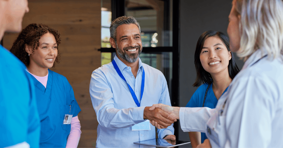 A healthcare team meets with a strategic business partner. 